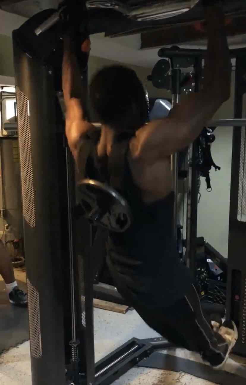 Weighted pull-up performed in a loaded vest