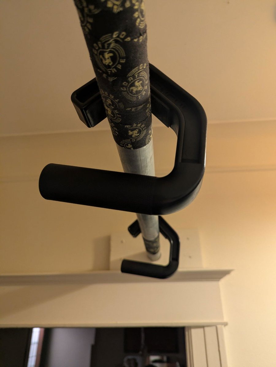 A Swissies V2 handle hooked over a home pull-up bar